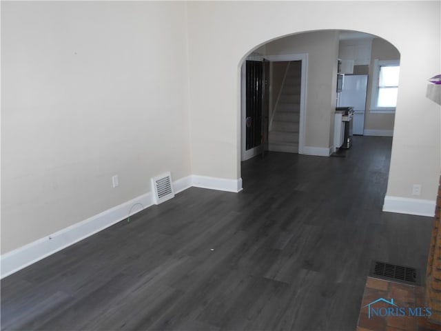 unfurnished room featuring dark wood-type flooring