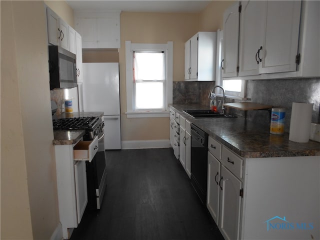 kitchen featuring white cabinets, appliances with stainless steel finishes, sink, and tasteful backsplash