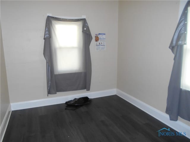 empty room featuring dark hardwood / wood-style flooring