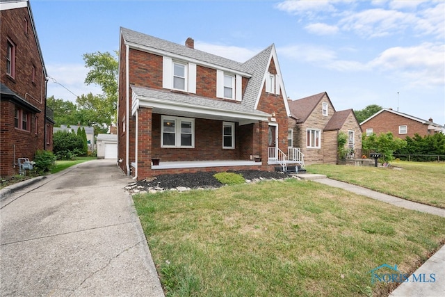 view of front of home with a front yard and a garage