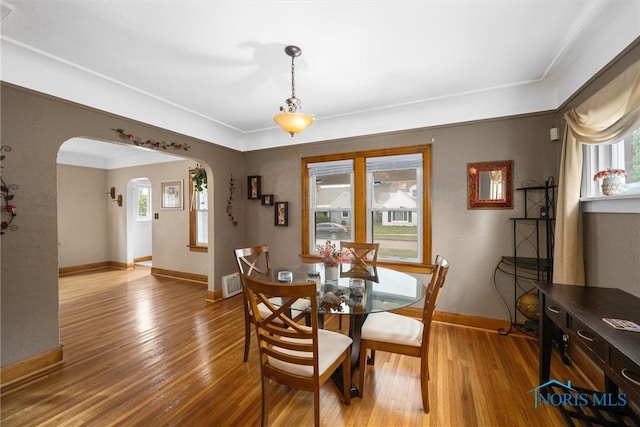 dining space with hardwood / wood-style flooring