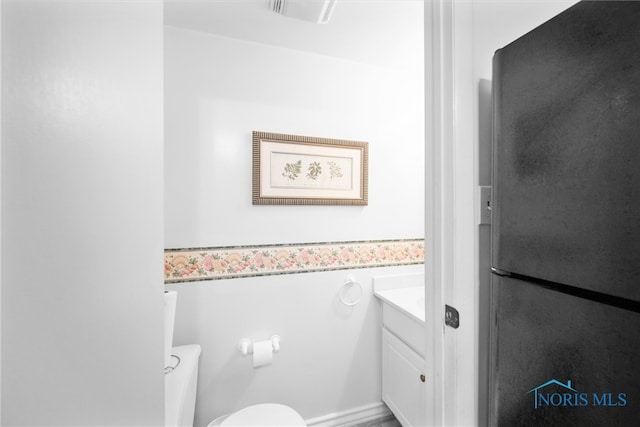 bathroom featuring vanity and toilet