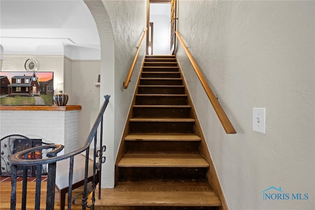 stairs featuring hardwood / wood-style floors