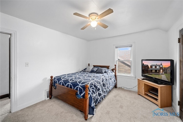 carpeted bedroom with vaulted ceiling and ceiling fan