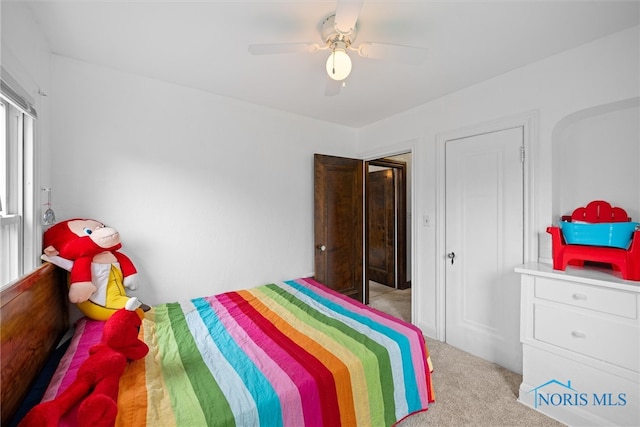 carpeted bedroom with ceiling fan