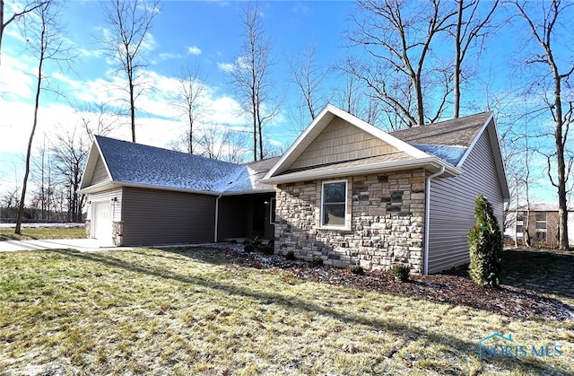 single story home featuring a garage and a front yard