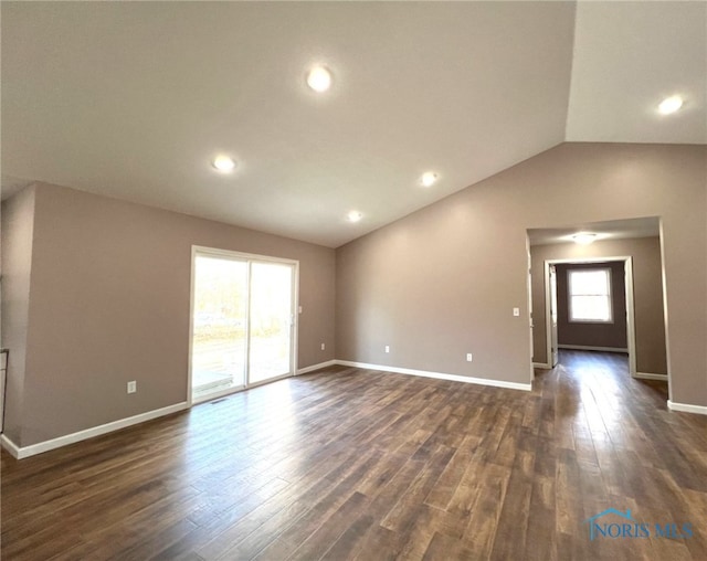 unfurnished room featuring vaulted ceiling and dark hardwood / wood-style floors