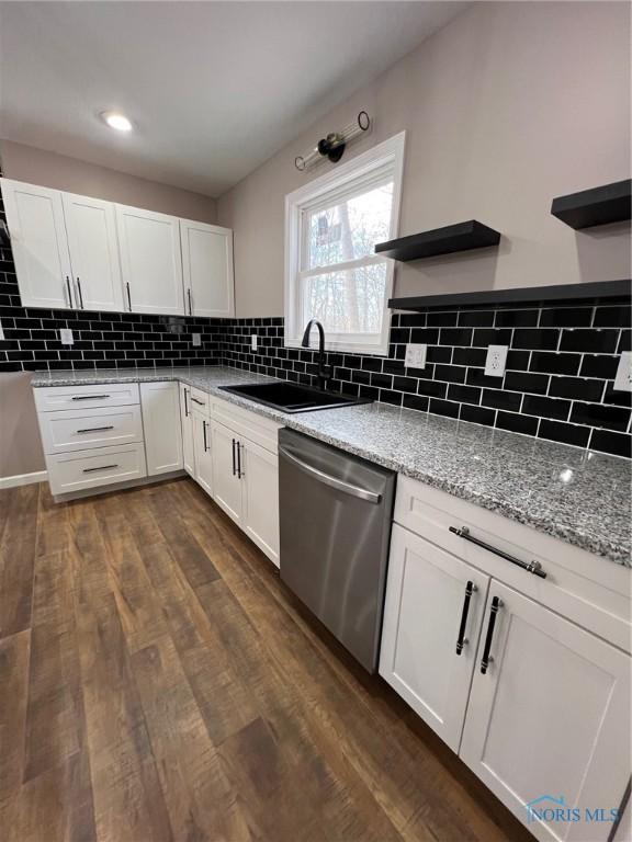 kitchen with white cabinetry, sink, and dishwasher