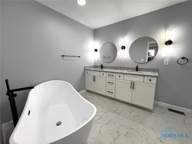 bathroom with vanity and a bathtub