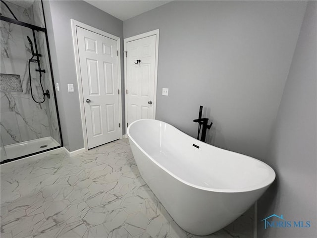 bathroom featuring shower with separate bathtub