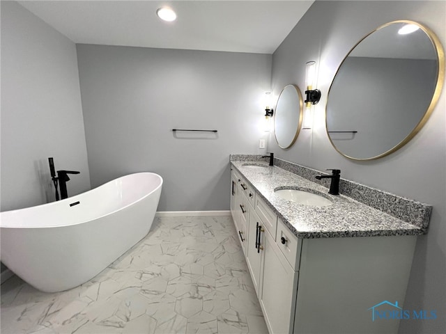 bathroom with vanity and a tub to relax in