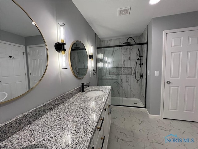 bathroom featuring an enclosed shower and vanity