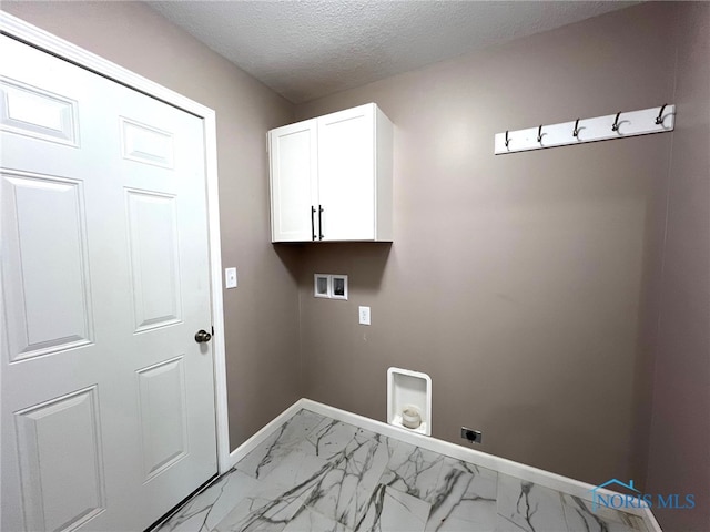 washroom featuring cabinets, washer hookup, a textured ceiling, and electric dryer hookup