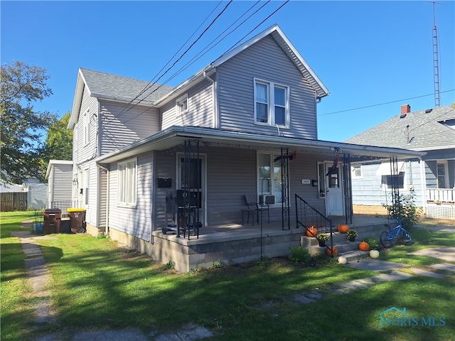 view of front of home with covered porch and a front yard