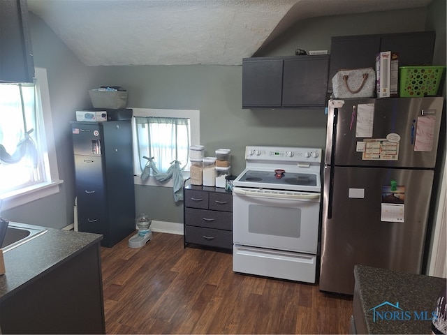 kitchen featuring white electric range, stainless steel fridge, dark hardwood / wood-style flooring, and a healthy amount of sunlight