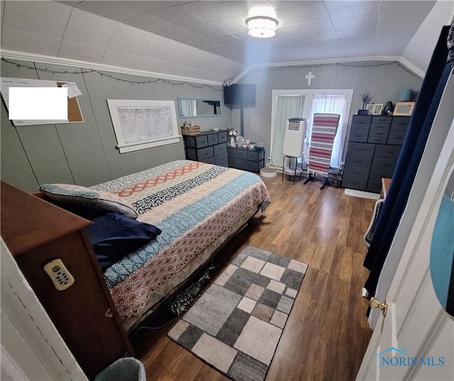 bedroom featuring wood-type flooring and lofted ceiling