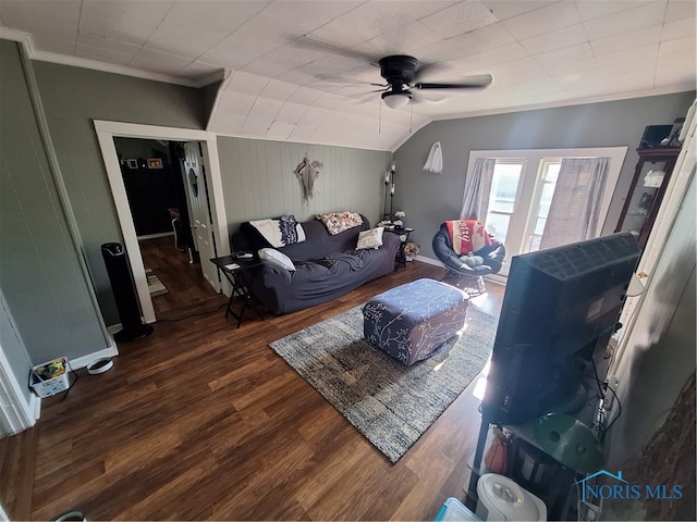 living room with lofted ceiling, ceiling fan, dark wood-type flooring, and crown molding