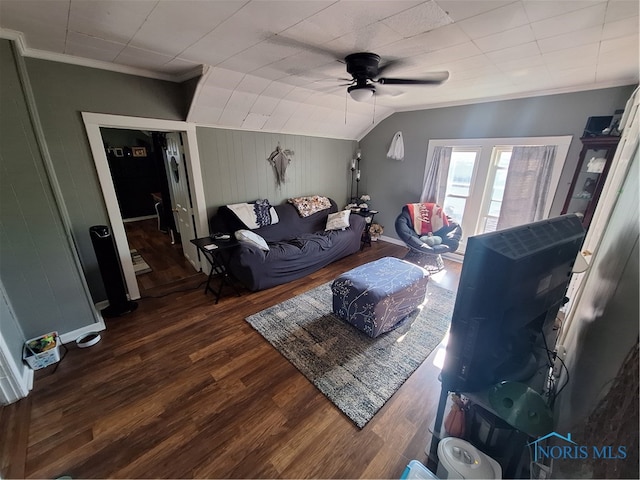 living room with ceiling fan, wood walls, ornamental molding, dark hardwood / wood-style floors, and vaulted ceiling