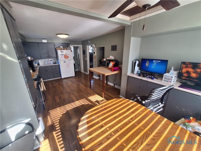 living room with vaulted ceiling and dark wood-type flooring