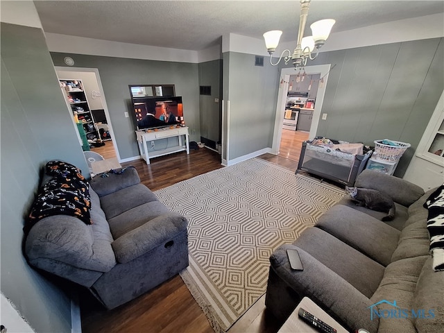 living room featuring wood-type flooring and a chandelier