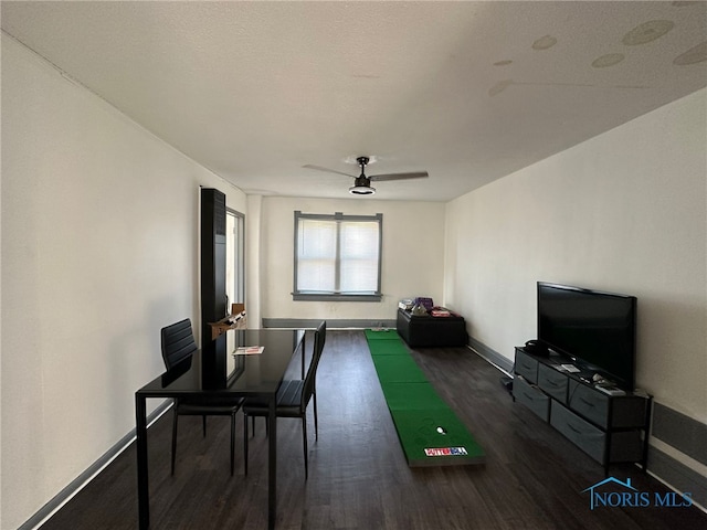 game room with ceiling fan and dark hardwood / wood-style floors