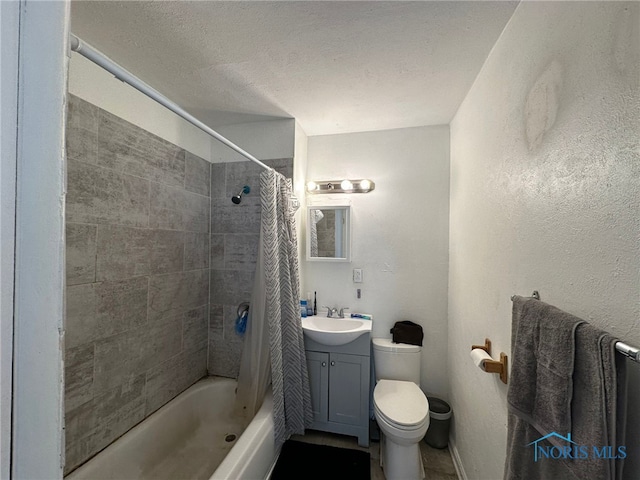 full bathroom with vanity, shower / tub combo, toilet, and a textured ceiling