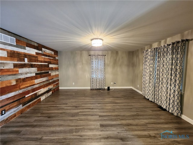 unfurnished room featuring dark hardwood / wood-style flooring