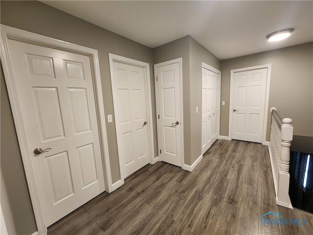 hallway with dark wood-type flooring