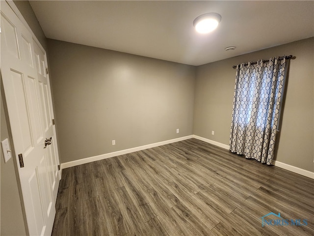 unfurnished bedroom featuring dark hardwood / wood-style flooring