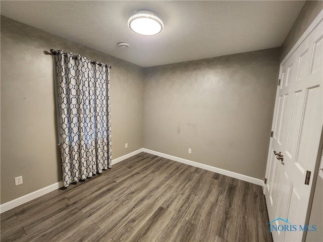 unfurnished bedroom featuring dark hardwood / wood-style flooring