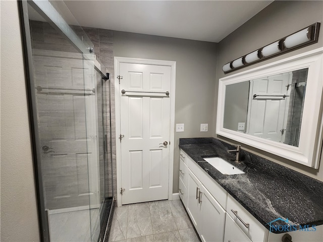 bathroom featuring walk in shower and vanity