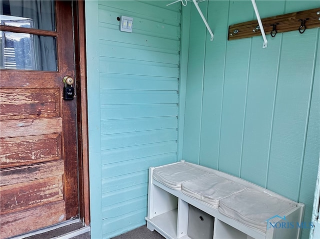 mudroom with wooden walls