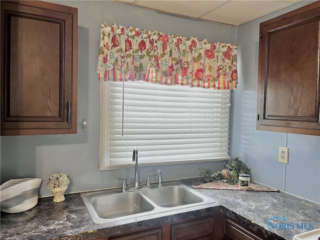 kitchen featuring dark brown cabinetry and sink