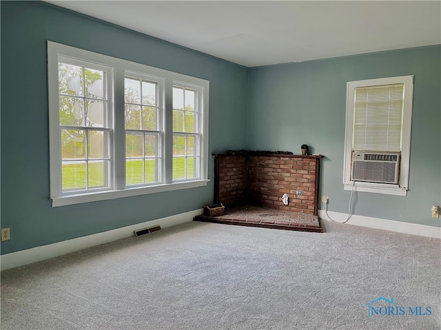 living room featuring a fireplace, carpet floors, and cooling unit