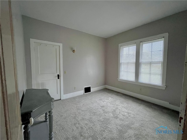 unfurnished room with light carpet