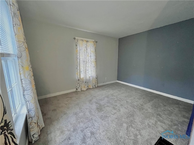 spare room featuring a wealth of natural light and carpet flooring