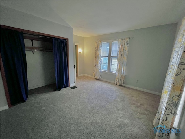 unfurnished bedroom with a closet and carpet