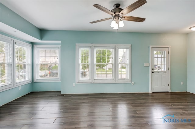 interior space featuring ceiling fan and dark wood-type flooring