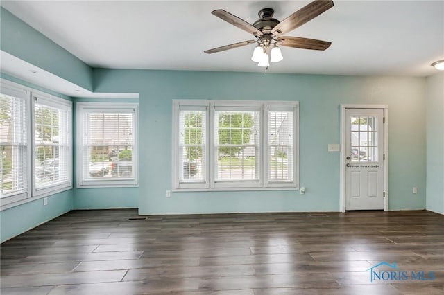 2915 N 109th St, Toledo, OH 43611 - unfurnished living room with plenty of natural light, a ceiling fan, and wood finished floors