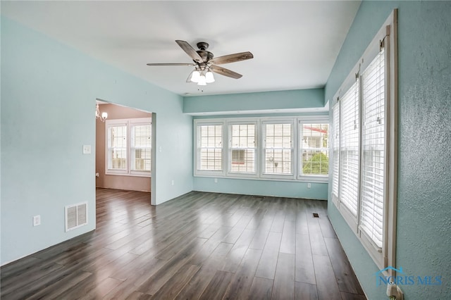 unfurnished room featuring ceiling fan and dark wood-type flooring