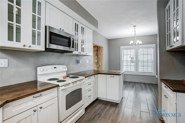 kitchen with electric range, white cabinets, an inviting chandelier, decorative light fixtures, and dark hardwood / wood-style flooring