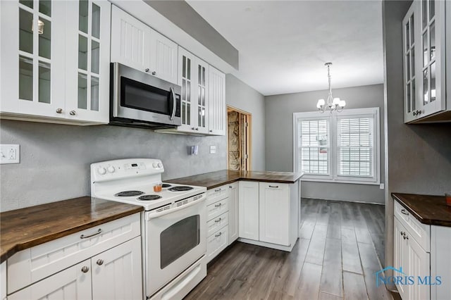 2915 N 109th St, Toledo, OH 43611 - kitchen with electric range, wooden counters, stainless steel microwave, a peninsula, and dark wood-style flooring