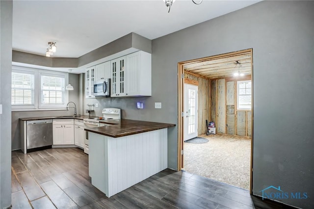 2915 N 109th St, Toledo, OH 43611 - kitchen featuring stainless steel appliances, dark wood-type flooring, a sink, glass insert cabinets, and white cabinets