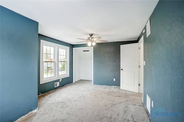 spare room featuring carpet and ceiling fan