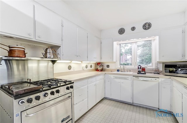 kitchen featuring dishwasher, white cabinets, high end stainless steel range oven, and sink