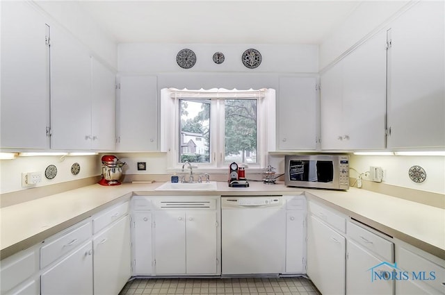 kitchen featuring dishwasher, white cabinets, and sink