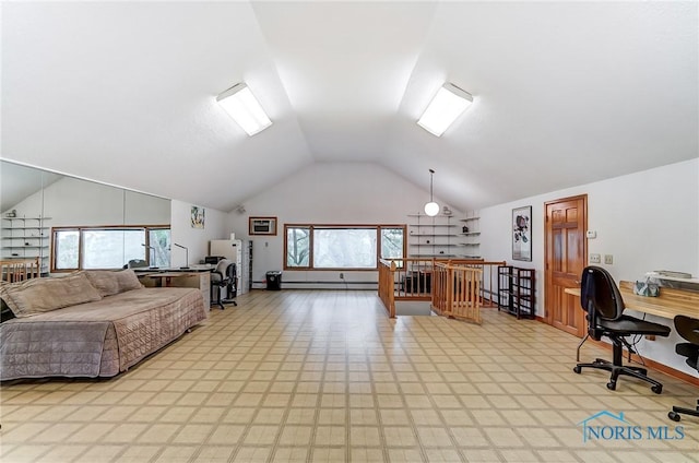 home office with baseboard heating, a healthy amount of sunlight, and lofted ceiling