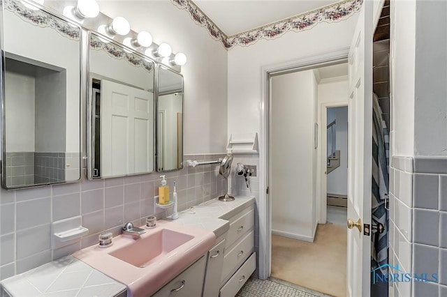 bathroom featuring vanity, tile patterned floors, baseboard heating, and backsplash