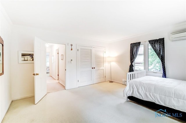 carpeted bedroom with an AC wall unit, ornamental molding, and a closet