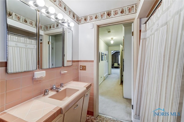 bathroom with vanity and tile walls